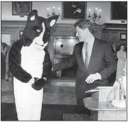  ??  ?? In honor of Otus’ 10 years of service, Gov. Bill Clinton proclaimed June “Otus the Head Cat Month” on June 6, 1989. Otus, who was indisposed that day, sent his Owner in an Otus suit as his surrogate.
