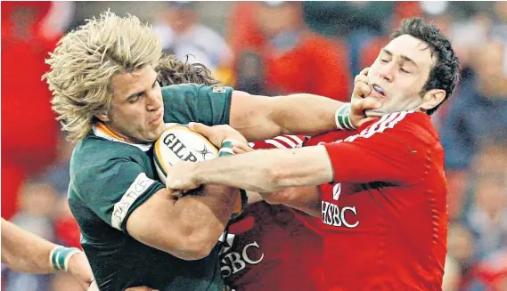  ??  ?? Last time: The British and Irish Lions Stephen Jones (right) tries to wrest the ball from South Africa centre Wynand Olivier during the third Test at Ellis Park, Johannesbu­rg, in 2009