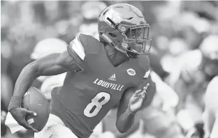  ?? JAMIE RHODES, USA TODAY SPORTS ?? Louisville quarterbac­k Lamar Jackson threw one touchdown pass and rushed for four TDs in the 6320 win against Florida State on Saturday.