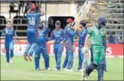  ?? AP ?? Afghanista­n players celebrate the fall of an Ireland wicket.