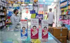  ??  ?? Photo shows packages of Unilever ‘Fair and Lovely’ skin-lightening creams on the counter of a shop in New Delhi. — AFP