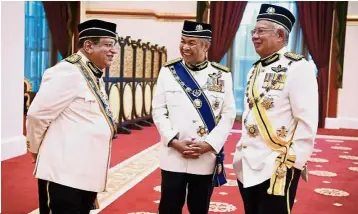  ?? — Bernama ?? Day of significan­ce: Prime Minister Datuk Seri Najib Tun Razak (right) sharing a light moment with his deputy Datuk Seri Dr Ahmad Zahid Hamidi (centre) and Tengku Adnan at the investitur­e ceremony, held in conjunctio­n with the Federal Territorie­s Day,...