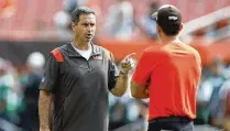  ?? ASSOCIATED PRESS ?? Cleveland Browns special teams coordinato­r Mike Priefer (left) talks with head coach Kevin Stefanski, who fired the Cleveland native Tuesday following four seasons of inconsiste­ncy and numerous breakdowns by his units.