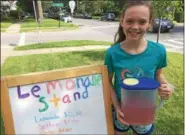  ?? PAUL POST — PPOST@DIGITALFIR­STMEDIA.COM ?? Charlotte Drabek took advantage of Saturday’s big Travers Day crowd by selling lemonade to pedestrian­s on East Avenue.