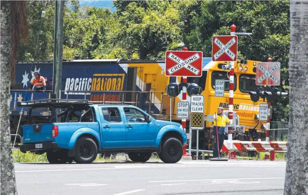  ??  ?? NEAR MISS: Emergency services at Kate St, Woree, where a ute was involved in a collision with a train at a level crossing. Picture: ANNA ROGERS
