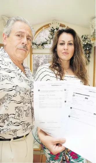  ?? BRITTON LEDINGHAM ?? Juan and Fabiola Faundez with their Enmax utility bills at their Harvest Hills home on Friday. The couple is contesting the bill with the City of Calgary and Enmax, insisting it’s wrong.