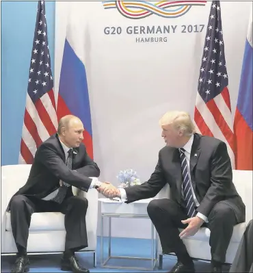  ?? MIKHAIL KLIMENTYEV — VIA ASSOCIATED PRESS ?? U.S. President Donald Trump, right, and Russian President Vladimir Putin shake hands during their first meeting at the G-20summit in Hamburg, Germany on Friday. The two leaders met for more than two hours.