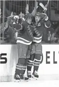  ?? BRUCE BENNETT/GETTY IMAGES ?? The Rangers’ Andrew Copp, left, celebrates his first-period goal with Artemi Panarin against the Penguins Thursday in New York.