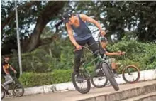  ??  ?? Sai Aung Zaw Myint, 14, performing a stunt in a park in Yangon.