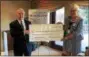  ?? SUBMITTED PHOTO ?? Marie Robinson, right, president of the Women’s Auxiliary Board to Chester County Hospital, presents a check to Kevin Holleran of the Chester County Hospital Foundation.