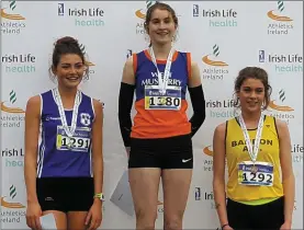  ??  ?? West Muskerry AC’s Stephanie Cotter (centre) proudly displays her AllIreland Junior title.