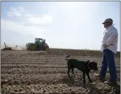  ?? GREGORY BULL — THE ASSOCIATED PRESS ?? Farmer Larry Cox walks in a plowed field with his dog, Brodie, at his farm Monday, Aug. 15, 2022, near Brawley With drought, climate change and overuse of the Colorado River leading to increasing­ly dire conditions in the West, the federal Bureau of Reclamatio­n is looking at fallowing as a way to cut water use. That means idling farmland, with payments to major users to make it worthwhile. That has farmers primarily in California’s Imperial Valley and Arizona’s Yuma Valley weighing the possibilit­y. Many are reluctant.