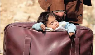  ??  ?? A CHILD sleeps in a bag in the village of Beit Sawa, eastern Ghouta, Syria, on March 15. Reuters African News Agency (ANA)