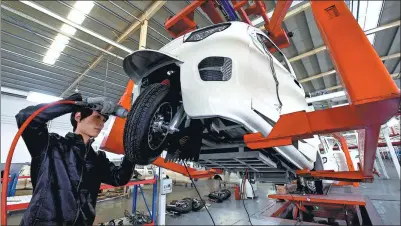  ?? WANG JILIN / FOR CHINA DAILY ?? A worker readies an electric car at a production line in Weifang, Shandong province.