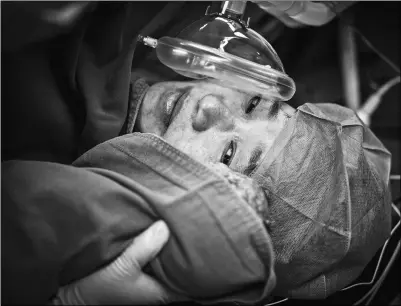  ?? JIADAI TENGFEI / FOR CHINA DAILY ?? Fang Zhiying, a 48-year-old woman who lost her 24-year-old firefighte­r son in a blast in Tianjin in 2015, looks at her newborn infant at Zhongnan Hospital in Wuhan, Hubei province, on Thursday.