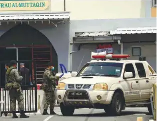  ??  ?? STRICT CHECKS ... Soldiers regulating the entry and exit of vehicles yesterday at the Seberang Perak Flats in Alor Star, Kedah that has been placed under an enhanced movement control order. – BERNAMAPIX