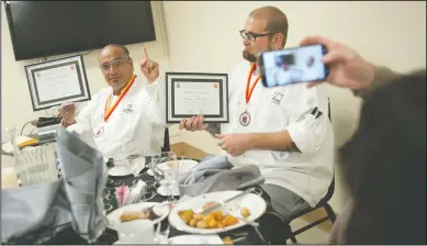  ?? NEWS-SENTINEL PHOTOGRAPH­S BY BEA AHBECK ?? Graduates Raymond Luna, left, and Brian McRavin pose for a picture during the Hope Harbor Culinary Arts program graduation at the Salvation Army in Lodi on Tuesday.
