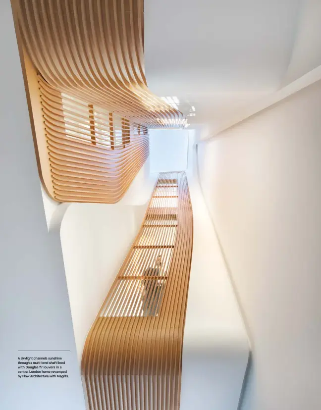  ??  ?? A skylight channels sunshine through a multi-level shaft lined with Douglas fir louvers in a central London home revamped by Flow Architectu­re with Magrits.