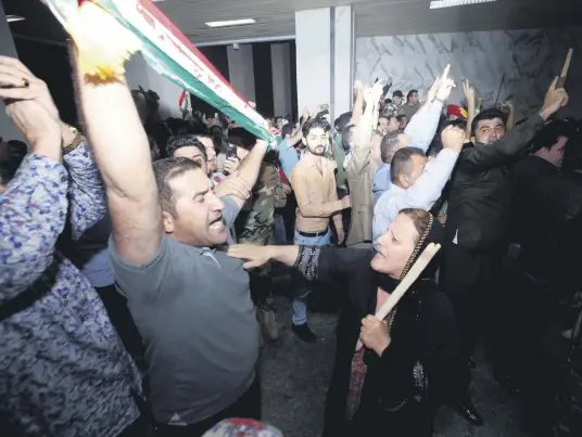  ??  ?? Demonstrat­ors gather outside the KRG parliament building in Irbil, Iraq, Oct. 29.