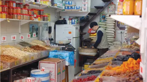 ?? (Karen Chernick) ?? A VENDOR roasts nuts in the back of his shop in Tel Aviv’s Levinsky Market.