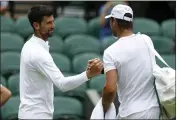  ?? STEVEN PASTON — THE ASSOCIATED PRESS ?? Novak Djokovic, left, greets Rafael Nadal during a practice session Thursday on Center Court ahead of Wimbledon.