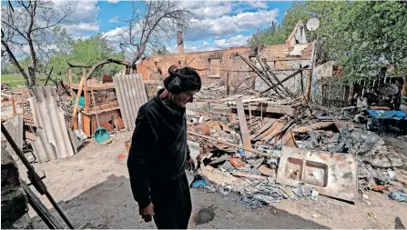  ?? | EPA ?? A MAN stands near the rubble of his destroyed home in Kozarovych­i village, Ukraine, yesterday. He lost his home after a shot-down military helicopter crashed into it and he and his wife have to live in a bomb shelter. According to the UN, more than 6 million refugees have fled Ukraine since Russia’s February invasion and a further 7.7 million people have been displaced internally within the country.