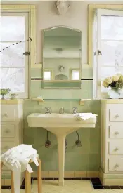  ??  ?? ABOVE This revival bath has a yellow border and black accent stripe to with go with pale-green 4" tiles. TOP The faceted yellow sink is original to the 1933 house. ABOVE RIGHT From 1928: lavender iridescent tiles are elegant with a curvy white tub.