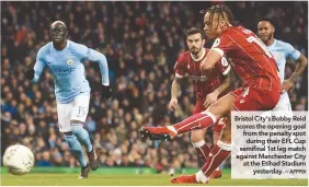  ?? AFPPIX ?? Bristol City’s Bobby Reid scores the opening goal from the penalty spot during their EFL Cup semifinal 1st leg match against Manchester City at the Etihad Stadium yesterday. –