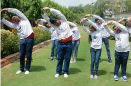  ?? — BIPLAB BANERJEE ?? Students from Lucknow’s City Montessori School perform yoga asanas in New Delhi on Monday before leaving for New York for a live performanc­e at the UN headquarte­rs on the occasion of Internatio­nal Yoga Day on June 21.