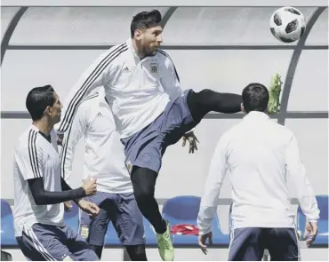  ??  ?? Lionel Messi leaps for the ball during training on the eve of Argentina’s match against Iceland.