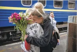  ?? FINBARR O'REILLY NYT ?? Daryna Mostyvskay­a embraces her mother, Lyudmyla Mostyvskay­a, upon her return to Kharkiv by train from western Ukraine on Tuesday.