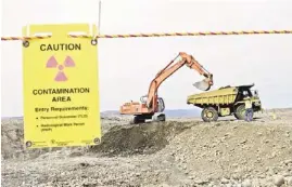  ?? AP ?? Workers use heavy machinery to remove waste near two dormant nuclear reactors May 6, 2004, on the Hanford Nuclear Reservatio­n near Richland, Wash.