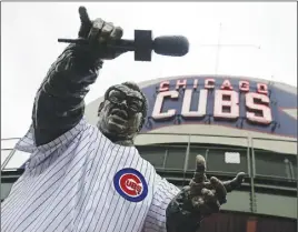  ?? Ap pHoto ?? The statue of Hall of Fame Chicago Cubs broadcaste­r Harry Caray wears a Cubs jersey outside Wrigley Field, site of Games 3, 4 and 5 of the World Series.