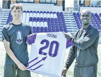  ??  ?? Sean Young, left, is welcomed to Pacific FC by head coach Pa-Modou Kah.