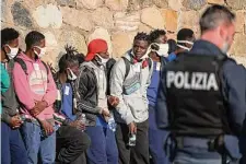  ?? Valeria Ferraro/Associated Press ?? Eighty-nine migrants disembark from a German rescue ship docked in the southern Italian port town of Reggio Calabria.