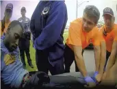  ?? AP FILE ?? Footage from a May 2019 body-camera video shows paramedics and police officers carrying Derrick Elliot Scott onto a stretcher after he was arrested and went in and out of consciousn­ess during his arrest in Oklahoma City.