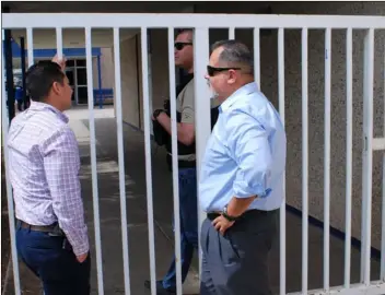  ?? PHOTO MICHAEL MARESH ?? El Centro police officer mans one of the gates at Central Union High School Monday following a social media post that threatened the school with violence.