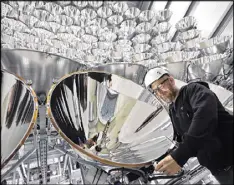  ?? CAROLINE SEIDEL / DPA VIA AP ?? Photo engineer Volkmar Dohmen stands in front of xenon short-arc lamps in the DLR German national aeronautic­s and space research center in Juelich, western Germany. The lights are part of an artificial sun that will be used for research purposes.