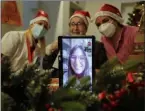  ??  ?? Carolina Previtali, 93, center, speaks remotely Saturday with Eleonora Nola, a donor unrelated to her who bought and sent her a Christmas present through an organizati­on dubbed “Santa’s Grandchild­ren.”