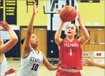  ?? Christian Abraham / Hearst Connecticu­t Media file photo ?? Greenwich's Ava Sollenne (1) ooks to score as Staples' Nicole Holmes (10) defends during FCIAC Girls' Basketball Quarterfin­als action against Staples in Trumbull, on Feb. 25, 2020.