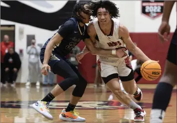  ?? PHOTO BY ANDREW FOULK ?? Centennial’s Jared Mccain dribbles the ball upcourt as Sherman Oaks Notre Dame’s Angelino Mark defends Tuesday.