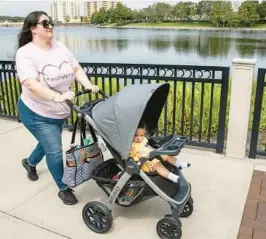  ?? ORLANDO SENTINEL WILLIE J. ALLEN JR./ ?? Catherine Hemperley wears her #visitsmatt­er T-shirt as she takes her 6-month-old grandson Kayden Collier out on a stroll at Cranes Roost Park in Altamonte Springs.