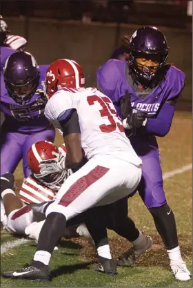  ?? Terrance Armstard/News-Times ?? In transition: El Dorado's Alex Boone throws a block during the Wildcats' 6A firstround playoff game against Pine Bluff Friday night at Memorial Stadium. A day after the Wildcats' season on the gridiron ended, Boone was on the basketball floor, playing in the Wildcats' season opener against West Memphis.