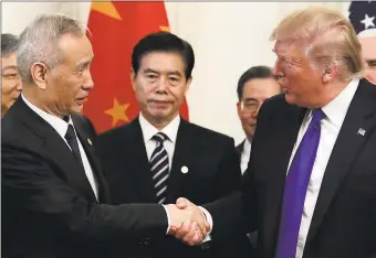  ?? Associated Press ?? President Donald Trump shakes hands with Chinese Vice Premier Liu He after signing a trade agreement in the East Room of the White House on Wednesday.