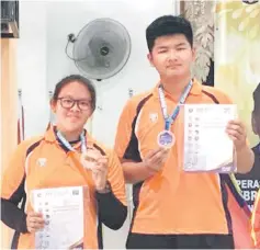  ??  ?? Supang and Jacky with their certificat­es and awards during the Inter-State Schools Sports Archery Championsh­ip in Kelantan.