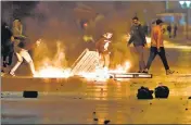  ?? AFP ?? Amid anger against virus curbs, protesters block a street on the northwestw­ern outskirts of Tunisia's capital Tunis.
