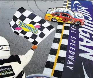  ?? Chris Trotman ?? The Associated Press Kyle Larson takes the checkered flag to claim the NASCAR Cup Series Firekeeper­s Casino 400 at Michigan Internatio­nal Speedway on Sunday. The victory was Larson’s second of the Cup season.