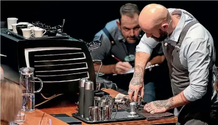  ?? PHOTOS: ANDREW TURNER ?? A judge scrutinise­s the coffee-making technique of 2018 National Barista Champion John Gordon in Upper Hutt last weekend.
