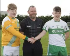  ??  ?? The captains with referee Ciaran Gough.