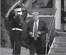  ?? SEMANSKY/ THE ASSOCIATED PRESS] ?? President Donald Trump walks on the South Lawn of the White House, Saturday, in Washington, after stepping off Marine One as he returns from Kennedy Space Center for the SpaceX Falcon 9 launch. [PATRICK